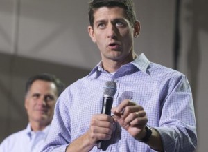 Serious Ryan with mike in hand speaks. Romney looks on adoringly in the background.